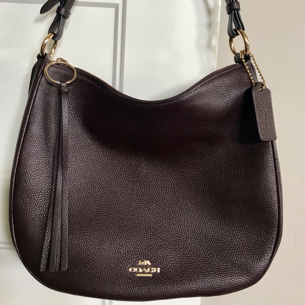 Coach shoulder bag with gold tone accents.